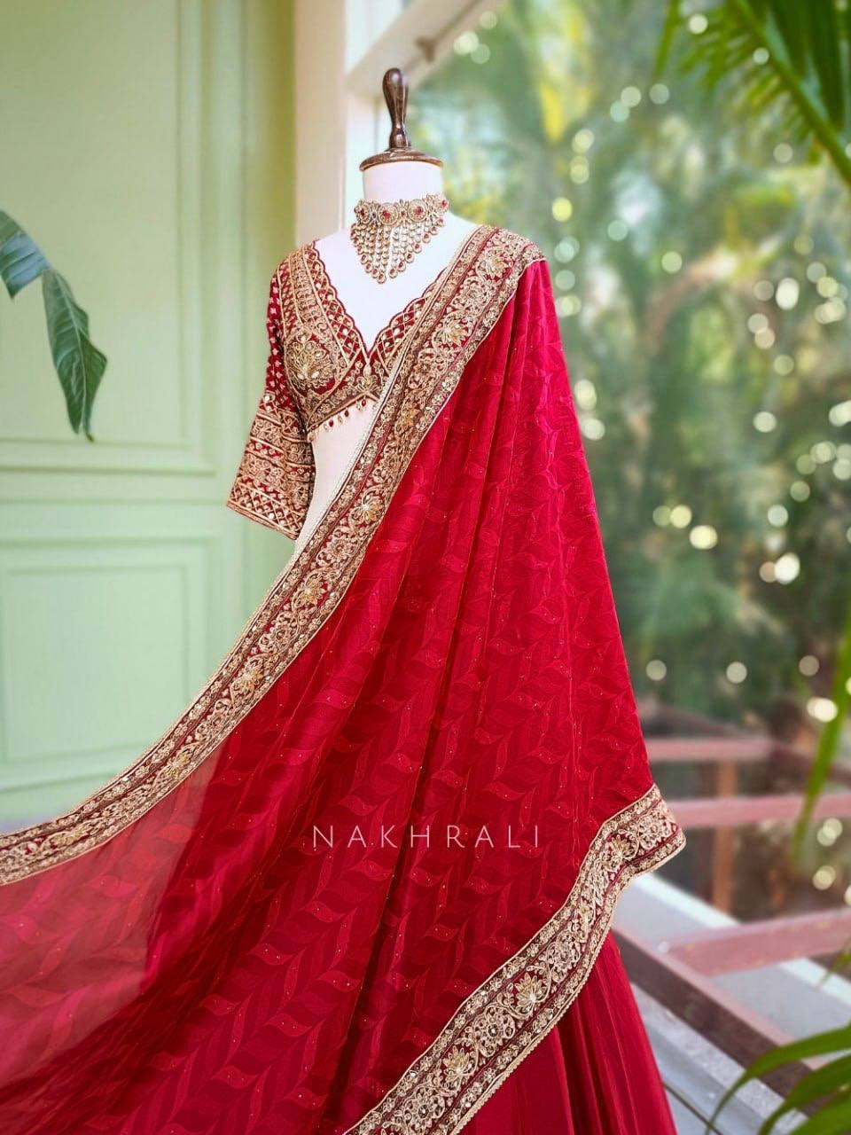 Regal Crimson Red Bridal Lehenga Choli Ensemble Featuring Intricate Gold Zari Embroidery, Heritage Motifs, and Embellished Tassels